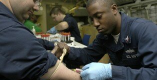 ATLANTIC OCEAN (March 5, 2008) Hospital Corpsman 3rd Class Michael Ousley draws blood from a patient to test for Human Immuno-deficiency Virus (HIV) during a physical health assessment aboard the aircraft carrier USS Theodore Roosevelt (CVN 71). Theodore Roosevelt is conducting carrier qualifications. U.S. Navy photo by Mass Communication Specialist Seaman Andrew Skipworth